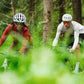 Two cyclists riding through a lush forest